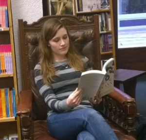 Me reading a book in Charlie Byrne's book shop