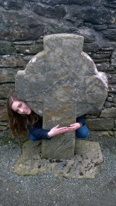 Me with my arms around a smaller stone cross.