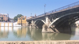 A beautiful sunny day in Sevilla and a view of the bridge that crosses over the river